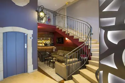a restaurant with a counter in the middle of a room at Best Western Plus Cannes Riviera & SPA in Cannes