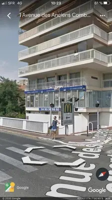 a person is standing in front of a building at appartement vue mer in Cannes
