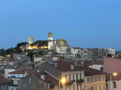 a city with a castle on top of a hill at appartement vue mer in Cannes