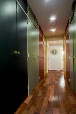 a hallway with glass doors and a hallway with wooden floors at appartement vue mer in Cannes