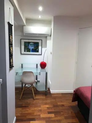 a bedroom with a desk and a chair in a room at appartement vue mer in Cannes