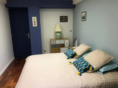 a bedroom with a large bed with two pillows at appartement vue mer in Cannes