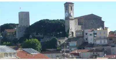 a city with a clock tower and buildings at appartement vue mer in Cannes
