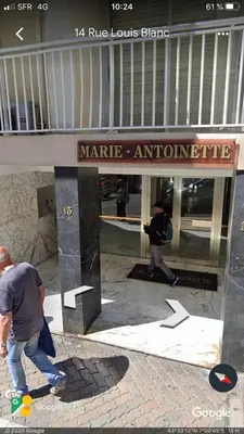 a man walking in front of a martinez entrance to a building at appartement vue mer in Cannes