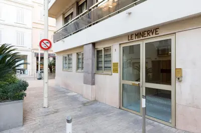 a building with a le imaging sign in front of it at Le Minerve YourHostHelper in Cannes