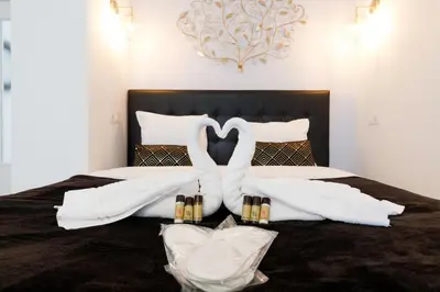 a bed with two swans made out of towels at Le Minerve YourHostHelper in Cannes