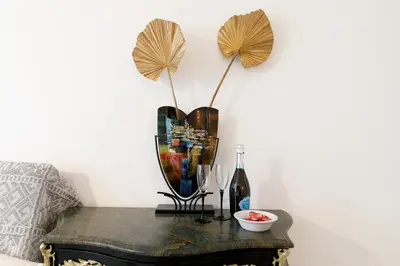 a table with a mirror and a bottle on it at Le Minerve YourHostHelper in Cannes