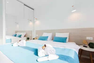 a bedroom with two beds with towels on them at L'Albion YourHostHelper in Cannes