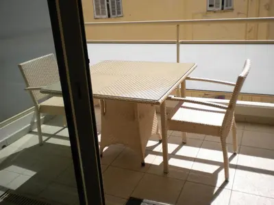 a table and chairs sitting on a balcony at Appartement Résidence Montaigne in Cannes