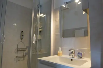 a bathroom with a sink and a shower at ATH hôtel Athénée in Cannes