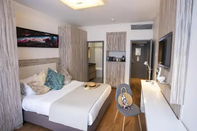 a hotel room with a bed and a chair at Eden Hotel & Spa in Cannes