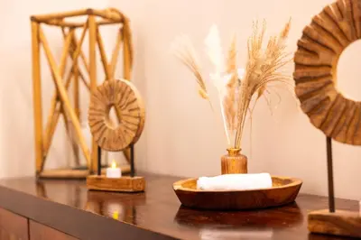 a wooden table with a bowl of towels and feathers at Eden Hotel & Spa in Cannes