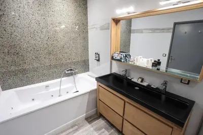 a bathroom with a tub and a sink and a bath tub at Eden Hotel & Spa in Cannes