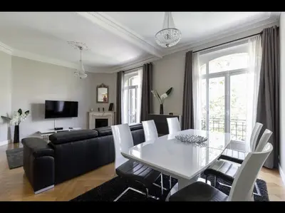 a living room with a white table and a couch at central CANNES - Luxury Clara Residence in Cannes