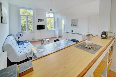 a living room with a table and a couch at IMMOGROOM - Suquet - 2 min from the beaches in Cannes
