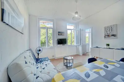 a living room with a couch and a table at IMMOGROOM - Suquet - 2 min from the beaches in Cannes