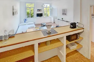 a large room with a table and a couch at IMMOGROOM - Suquet - 2 min from the beaches in Cannes