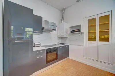 a kitchen with stainless steel appliances and white walls at IMMOGROOM - Suquet - 2 min from the beaches in Cannes