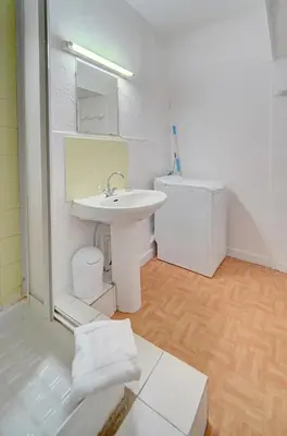 a white bathroom with a sink and a toilet at IMMOGROOM - Suquet - 2 min from the beaches in Cannes