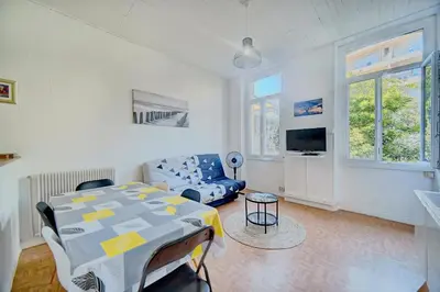 a living room with a table and a couch at IMMOGROOM - Suquet - 2 min from the beaches in Cannes