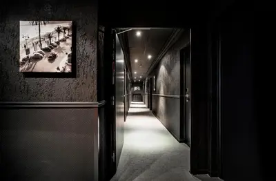 a hallway in a building with a picture on the wall at Hotel Schtak in Cannes