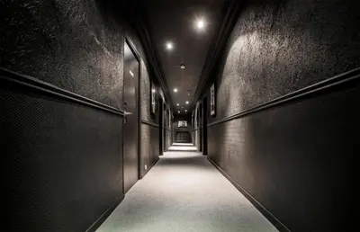 a hallway with dark walls and a long corridor at Hotel Schtak in Cannes