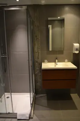 a bathroom with a sink and a shower at Hotel Schtak in Cannes