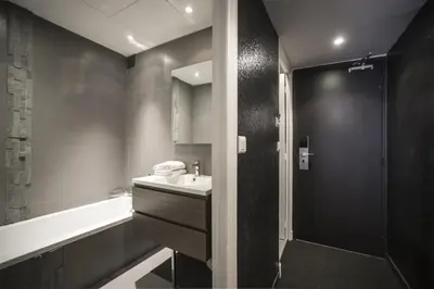a bathroom with a sink and a tub and a shower at Hotel Schtak in Cannes