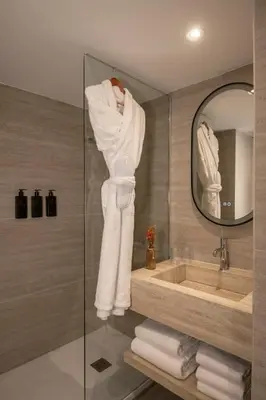 a bathroom with a sink and a mirror at Le Cetai Cannes Beach Hotel in Cannes