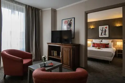 a hotel room with a bed and a mirror at Le Cetai Cannes Beach Hotel in Cannes