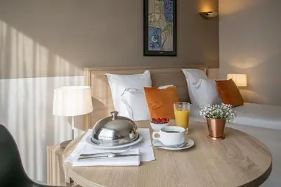 a hotel room with a table with a tea pot on it at Le Cetai Cannes Beach Hotel in Cannes