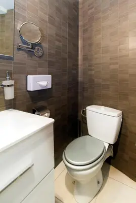 a bathroom with a toilet and a sink and a mirror at Florella République Apartment in Cannes
