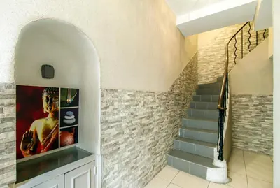 a staircase in a house with a painting on the wall at Florella République Apartment in Cannes