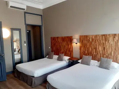 a hotel room with two beds in a room at Hôtel La Villa Tosca in Cannes