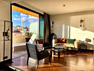 a living room with a couch and a table at Hôtel Cannes Centre Univers in Cannes