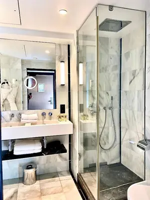 a bathroom with a shower and a sink at Hôtel Cannes Centre Univers in Cannes