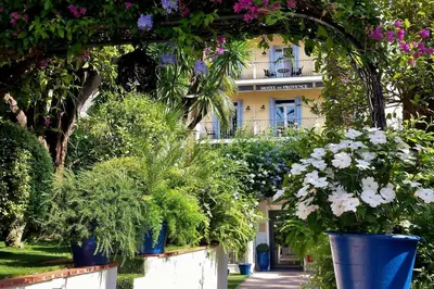 a hotel room with a bed and a window at Hôtel de Provence in Cannes
