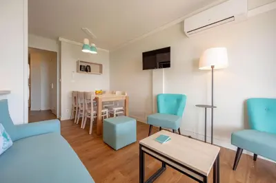 a living room with a couch and a table at Résidence Pierre & Vacances Cannes Verrerie in Cannes