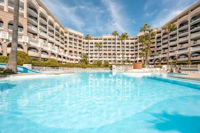 a large swimming pool in front of a large building at Résidence Pierre & Vacances Cannes Verrerie in Cannes