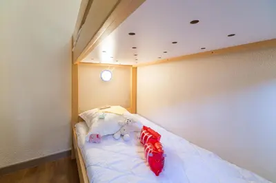 a small bed with two stuffed animals on it at Résidence Pierre & Vacances Cannes Verrerie in Cannes