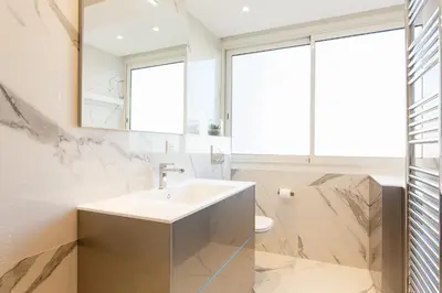 a bathroom with a sink and a mirror at On La Croisette: new 2 bedrooms with sea view in Cannes