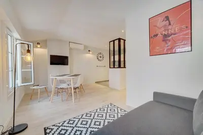 a living room with a couch and a table at IMMOGROOM - AC - 5min from the beaches 8 min from Palais in Cannes