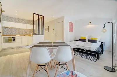 a bedroom with a bed and a table and chairs at IMMOGROOM - AC - 5min from the beaches 8 min from Palais in Cannes