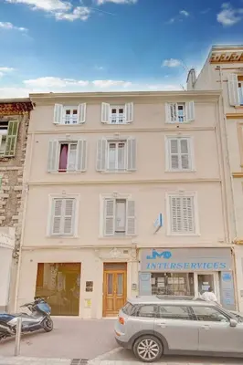 a building with a car parked in front of it at IMMOGROOM - AC - 5min from the beaches 8 min from Palais in Cannes