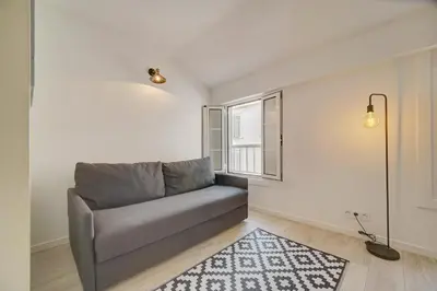 a living room with a couch and a window at IMMOGROOM - AC - 5min from the beaches 8 min from Palais in Cannes