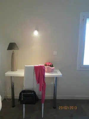 a white desk with a table with a towel on it at Hôtel Ligure in Cannes