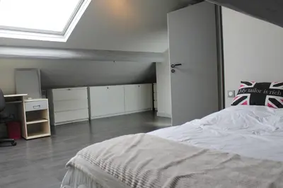 a bedroom with a large bed and a skylight at Rooftop grande terrasse jacuzzi vue mer in Cannes