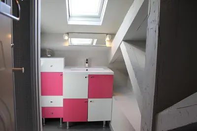 a bathroom with a red and white cabinet and a sink at Rooftop grande terrasse jacuzzi vue mer in Cannes