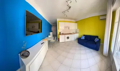 a living room with a blue and yellow wall at PASTEUR in Cannes