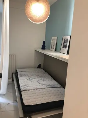 a bedroom with a bed on a shelf and a light at Studio contemporain à Cannes avec terrasse et parking - 35 m² in Cannes